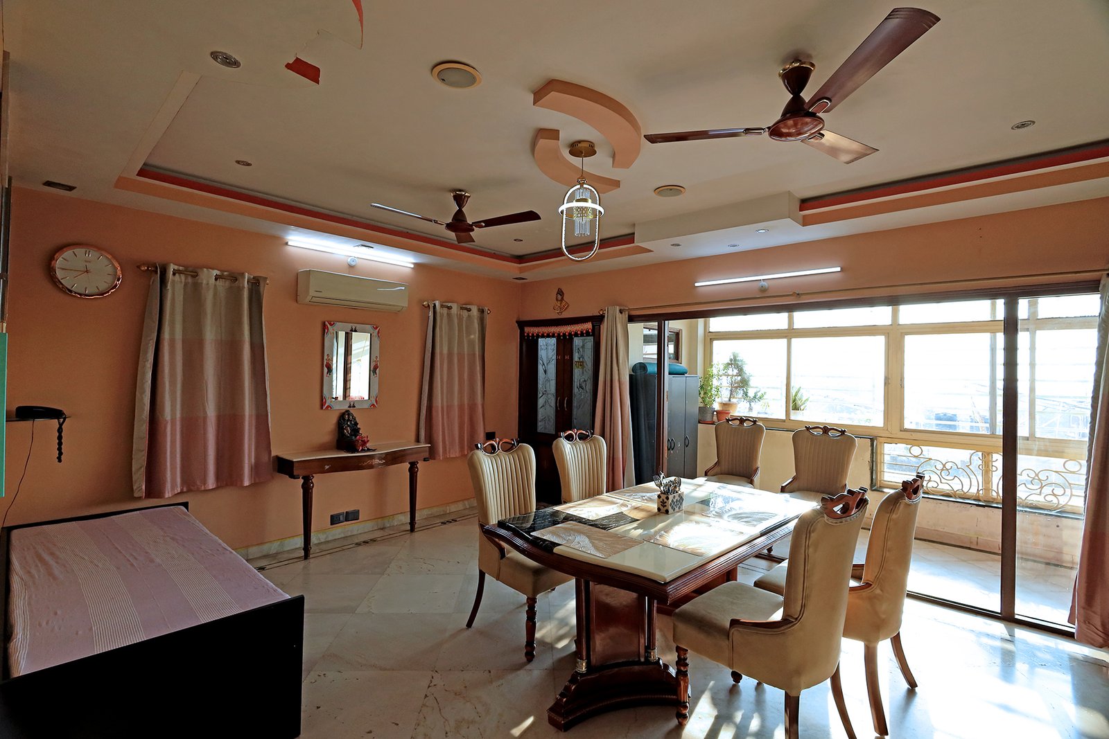 Dining table beside the huge attached balcony, filled with natural light
