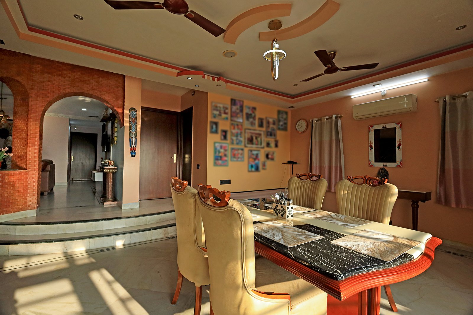 Spacious, sunlit dining room with archway through to the living room
