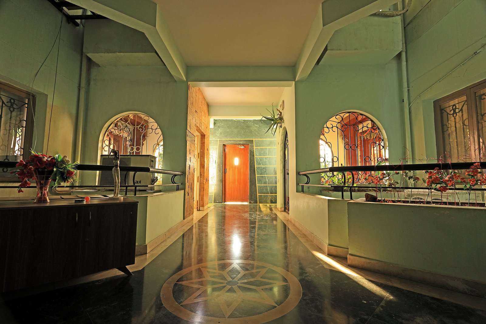 Bright building corridor leading to the flat's entrance